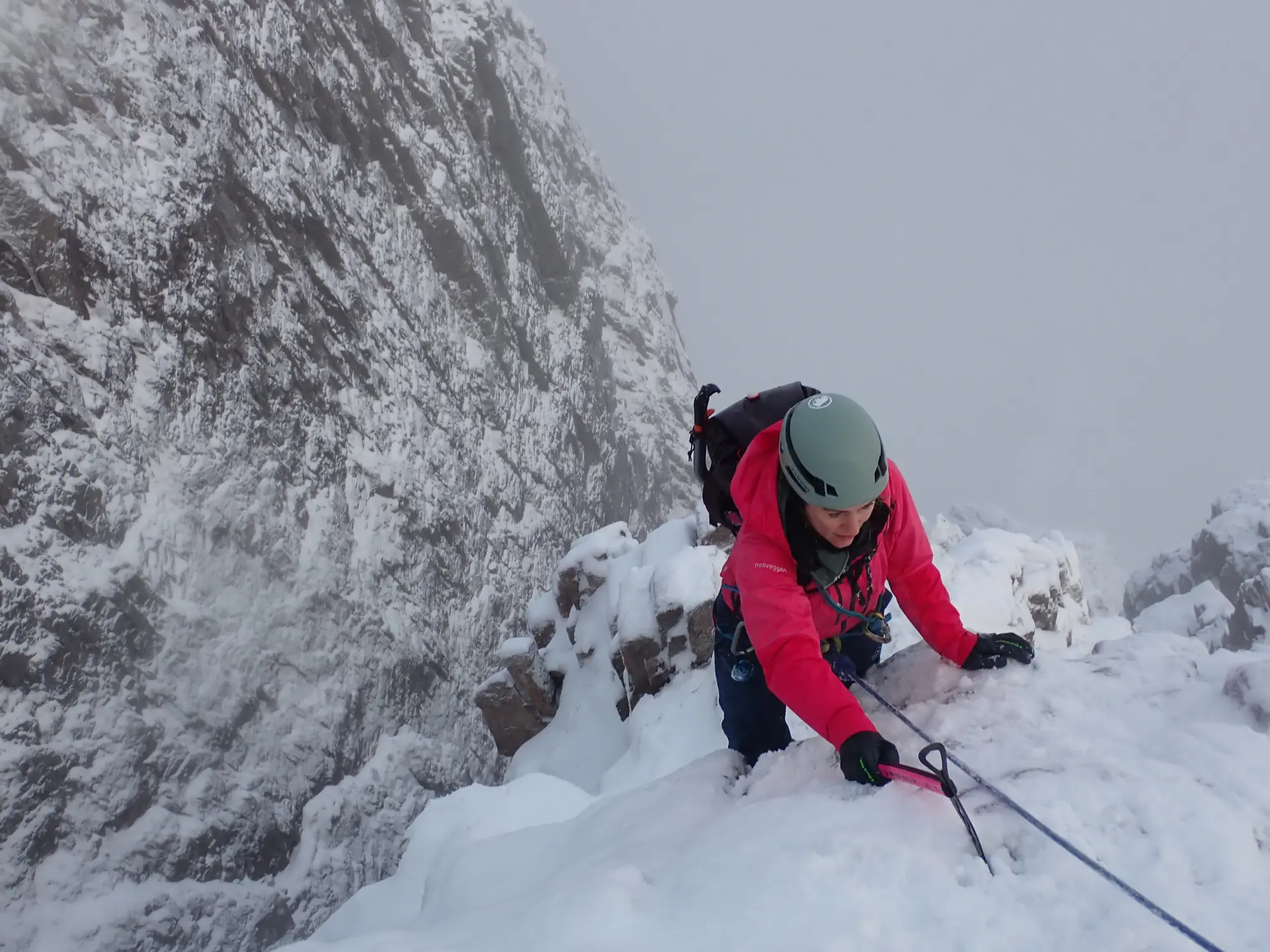 Climber on steep snowy mountain terrain