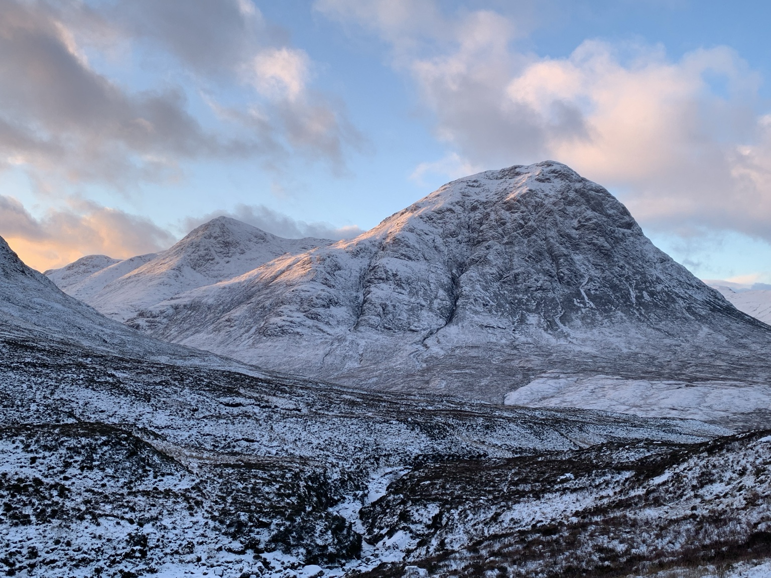 Snow-covered mountain beneath a softly coloured winter sky