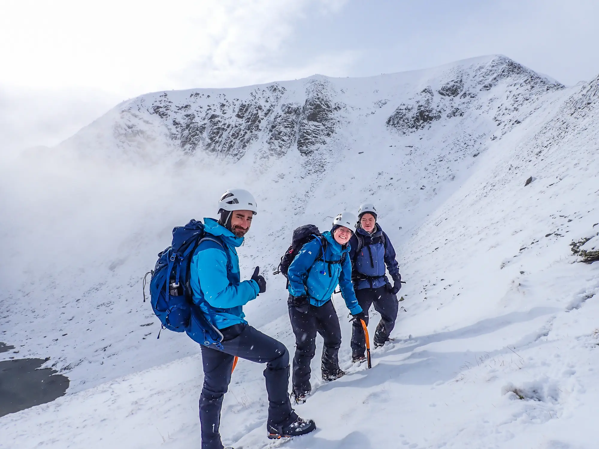 Three mountaineers on a snowy mountain slope